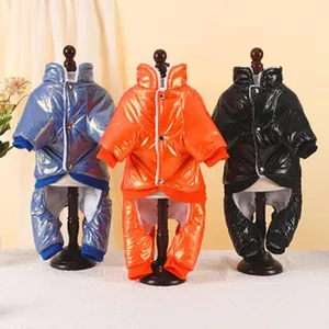 Close-up of three colorful shiny winter pet puffer jumpsuits displayed on mannequins