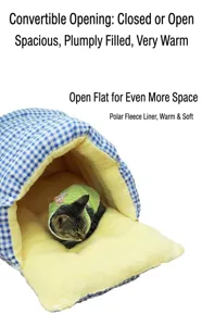 Close-up of cozy cat sleeping inside a blue checkered bed with soft yellow fleece lining