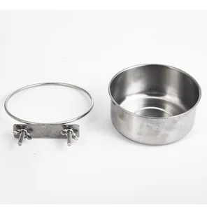 Detail view showing a stainless steel pet bowl alongside its metal cage mounting bracket set