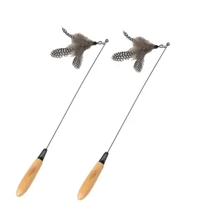 Detailed macro view of an interactive cat teaser wand with wooden handle and feathers