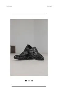 Detail view of premium black textured leather loafers with a comfortable slip-on design