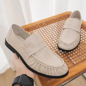 Elegant beige crocodile-textured leather loafers for a sophisticated classic casual look.