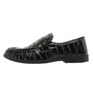 Lightweight men's black designer loafers with unique pleated texture and slip-on design.