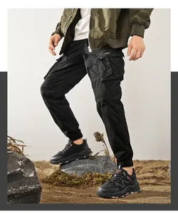 Close-up of men's black cargo pants paired with rugged outdoor hiking sneakers