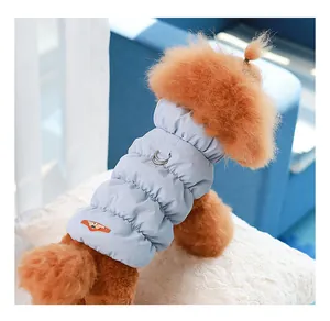 Detail of blue quilted winter dog vest featuring a back D-ring for leash attachment.