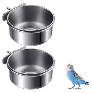 Detail view showing two stainless steel bird feeding bowls with cage mounting brackets
