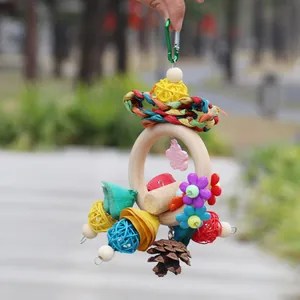 Handmade bird foraging toy featuring a wooden ring and vibrant colorful rattan balls