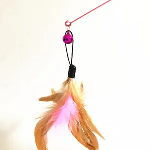 Detailed close-up of a feather cat toy replacement head featuring a vibrant pink bell