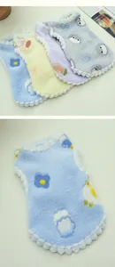 Soft plush pet winter vest showing warm fleece texture and cute cartoon flower patterns