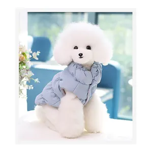 Detailed view of a light blue pet winter puffer vest on a small white fluffy dog