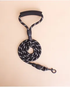 Detail view of a reflective black and white rope dog leash with a soft foam handle