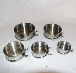 Macro view of five different sizes of stainless steel bird cage feeder bowls with mounting bolts.