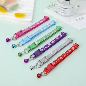 Six colorful pet collars with paw print patterns and metal bells for small dogs and cats