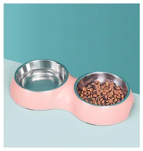 Detailed view of pink double pet bowl with stainless steel inserts for food and water