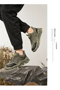 Men's olive green outdoor hiking shoes with breathable soft soles in a rocky setting.
