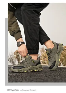 Detailed macro shot of men's olive green outdoor hiking shoes shown on asphalt ground.