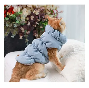 Detailed side view of a warm light blue winter puffer vest jacket for cats and small dogs