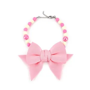 Detailed view of an elegant pink pet collar featuring a large bow and pastel beads