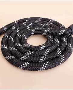 Close-up view of a durable black and white reflective dog leash with thick braided rope texture