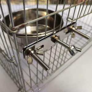 Detail view of the stainless steel pet bowl with a secure screw-on cage mounting bracket