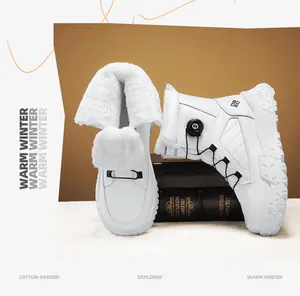 Detail view of men's white snow boots featuring thick faux fur lining and rotary dial.