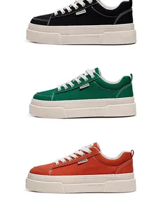 Detailed view of thick-sole canvas sneakers in black, green, and orange colors.