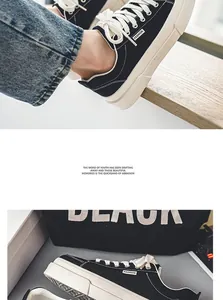 Detail view of men's Harajuku style thick-sole black canvas sneakers in outdoor setting