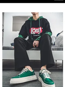 Close-up of men's green thick-sole canvas sneakers in a Harajuku-inspired lifestyle scene.