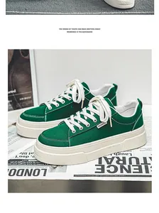 Detailed view of green canvas shoes with thick soles and white laces on a newspaper prop