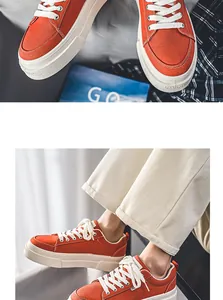 Detailed view of men's orange Harajuku style thick-sole canvas sneakers being worn