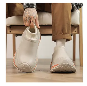 Detailed view of beige warm platform clogs featuring a cozy ribbed knit sock collar.
