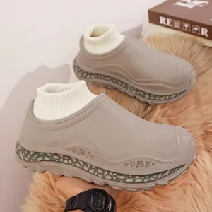 Grey fleece-lined winter slippers with platform sole and warm knitted sock cuff detail