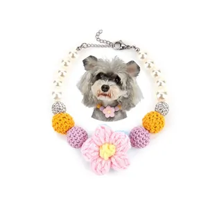 Detailed macro view of colorful crochet flower and pearl pet collar necklace for cats