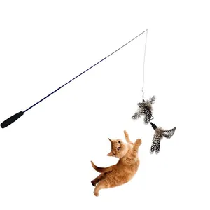 Action shot of a ginger cat jumping for the feather on a telescopic teaser wand