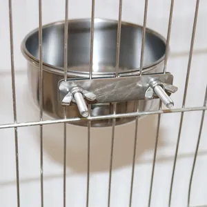 Macro view of the durable stainless steel parrot feeder bowl with screw cage mount.