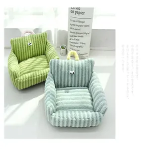 Close-up of striped sofa-shaped pet beds with cute eye details in macaron colors.