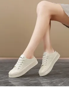 Detail view of women's off-white platform canvas sneakers worn with FASHION tag