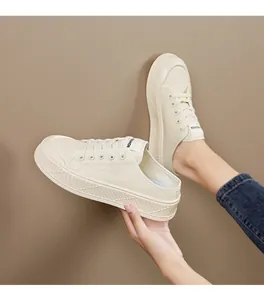 Detailed view of beige canvas platform sneakers with lace-up design and thick sole