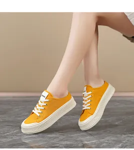 Detailed shot of yellow women's canvas sneakers with textured anti-slip white soles