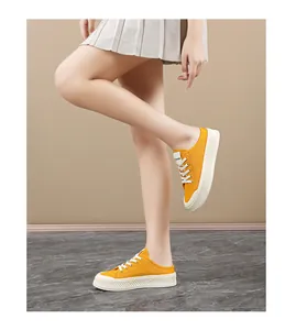 Side detail view of vibrant yellow canvas slip-on platform sneakers worn by a model