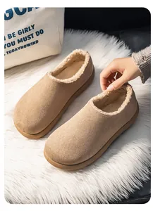 Macro detail of camel suede slippers with warm cream fleece lining on white fur