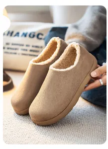 Detail view of men's brown suede slip-on loafers with warm cream fleece lining for winter