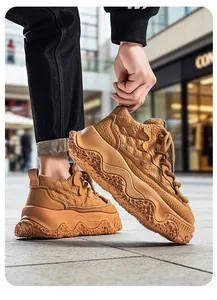 Detailed view of camel brown chunky sneakers with quilted leather and wavy platform soles.