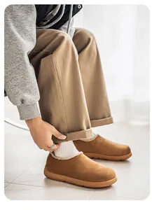 Detail view of brown suede plush-lined slip-on shoes for men in a casual setting