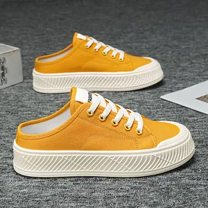 Bright yellow canvas mule sneakers for women with chunky white platform soles
