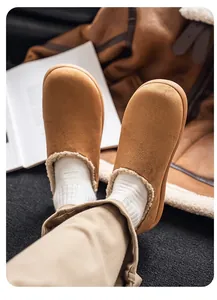 Detail view of men's tan fleece-lined clogs with cozy winter jacket in background