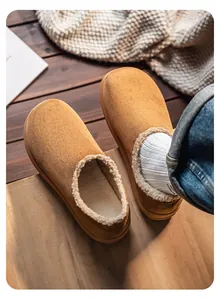 Detailed macro view of camel suede slippers with cozy shearling lining texture.