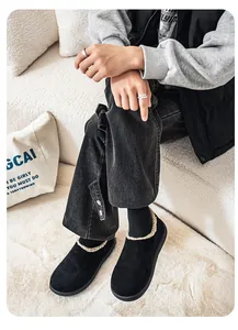 Black men's shearling-lined slip-on clogs shown in a cozy home setting lifestyle shot