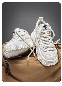 Detailed view of chunky off-white platform sneakers on a rustic brown canvas bag.