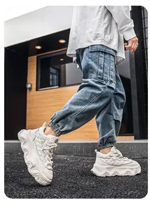 Close-up of white high-top chunky sneakers for outdoor casual wear.